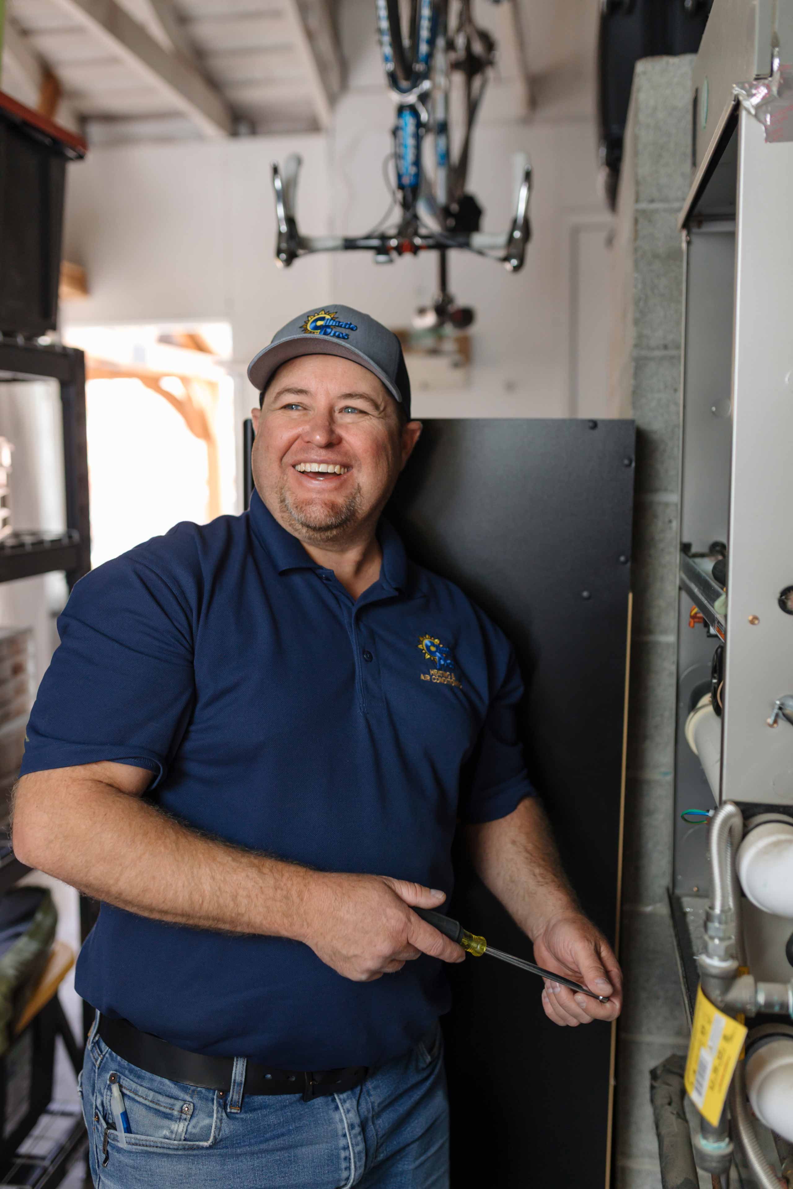 climate pros tech doing a repair on a cooling system