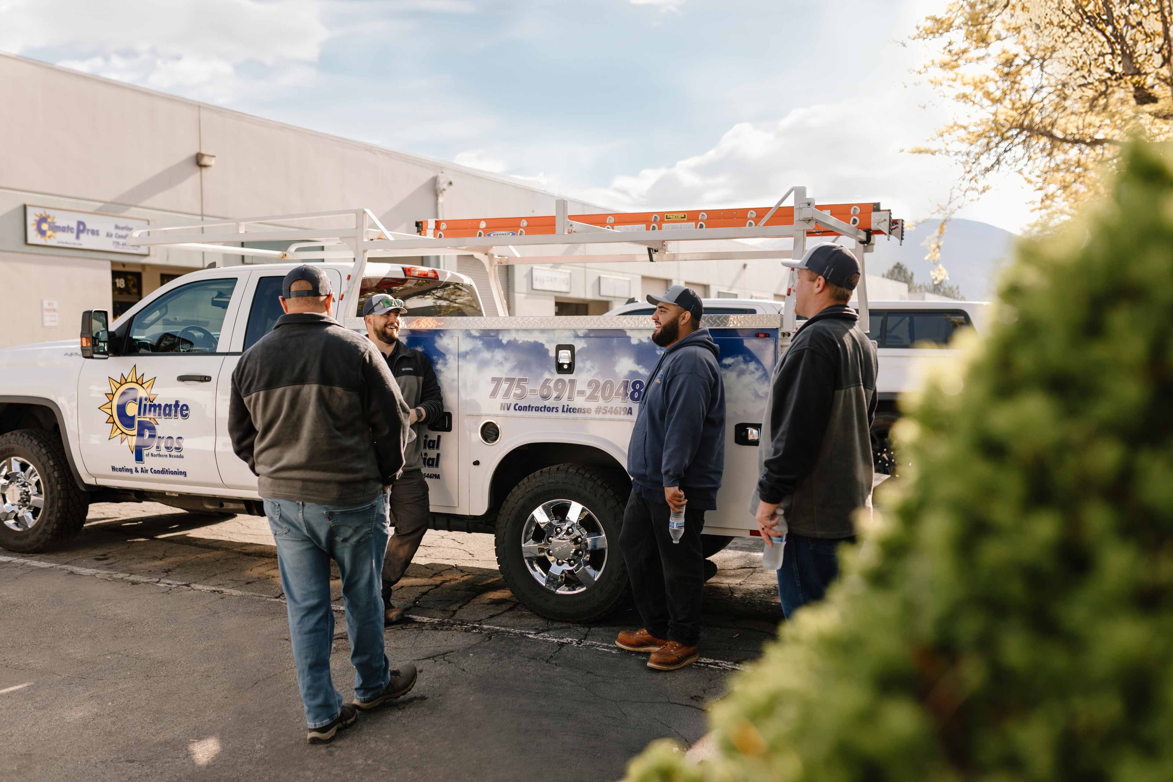 climate pros crew standying by their trucks