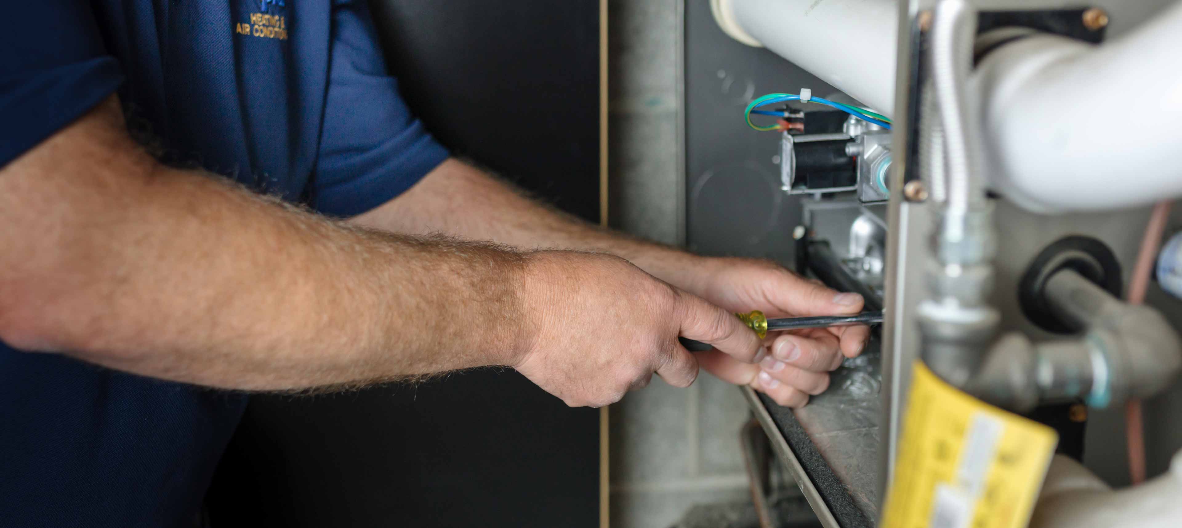 climate pros tech doing a repair to a commercial cooling system