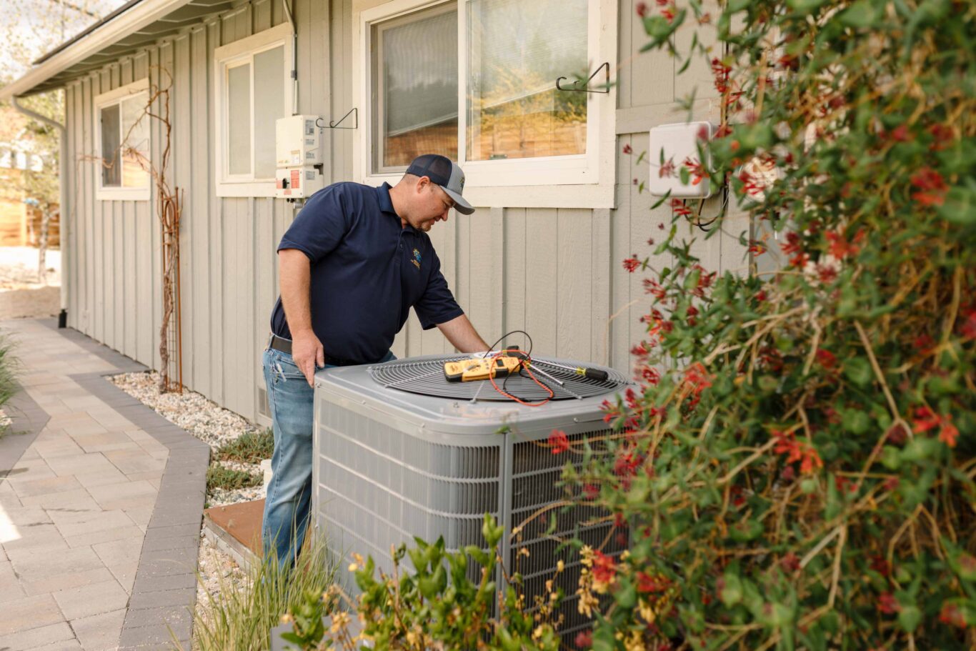 climate pros tech doing maintenance on a big ac unit