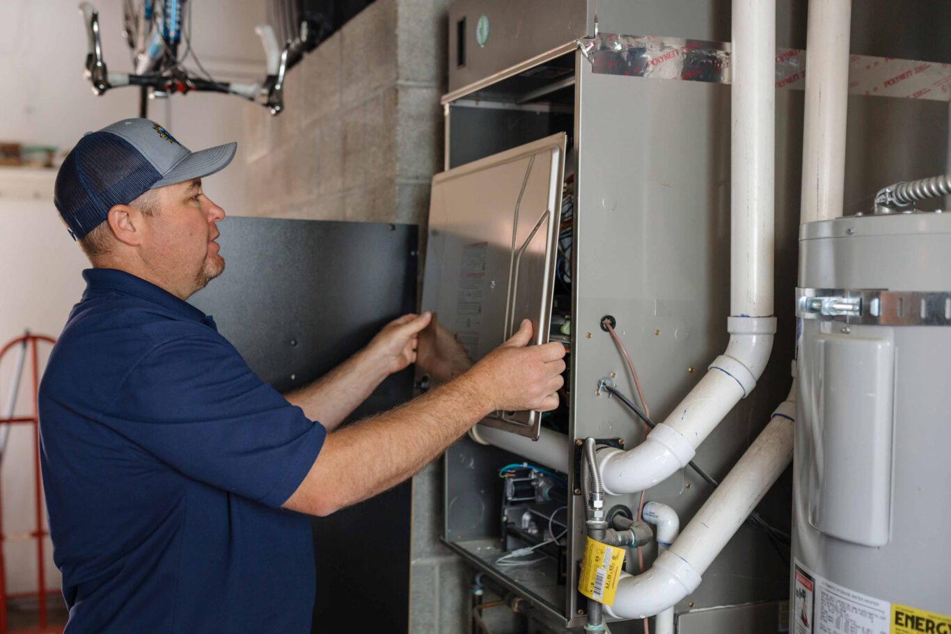 climate pros tech working on a heating panel