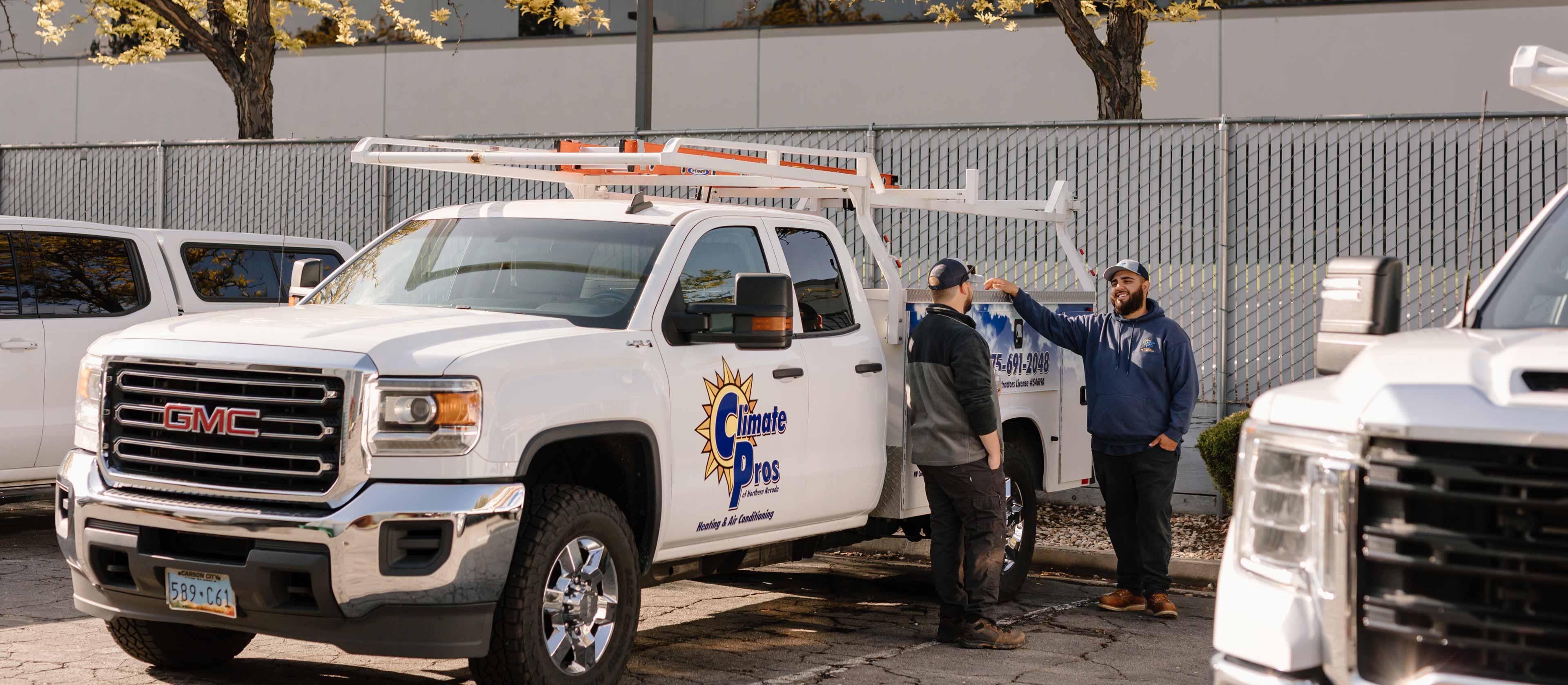 climate pros techs talking about business near their trucks