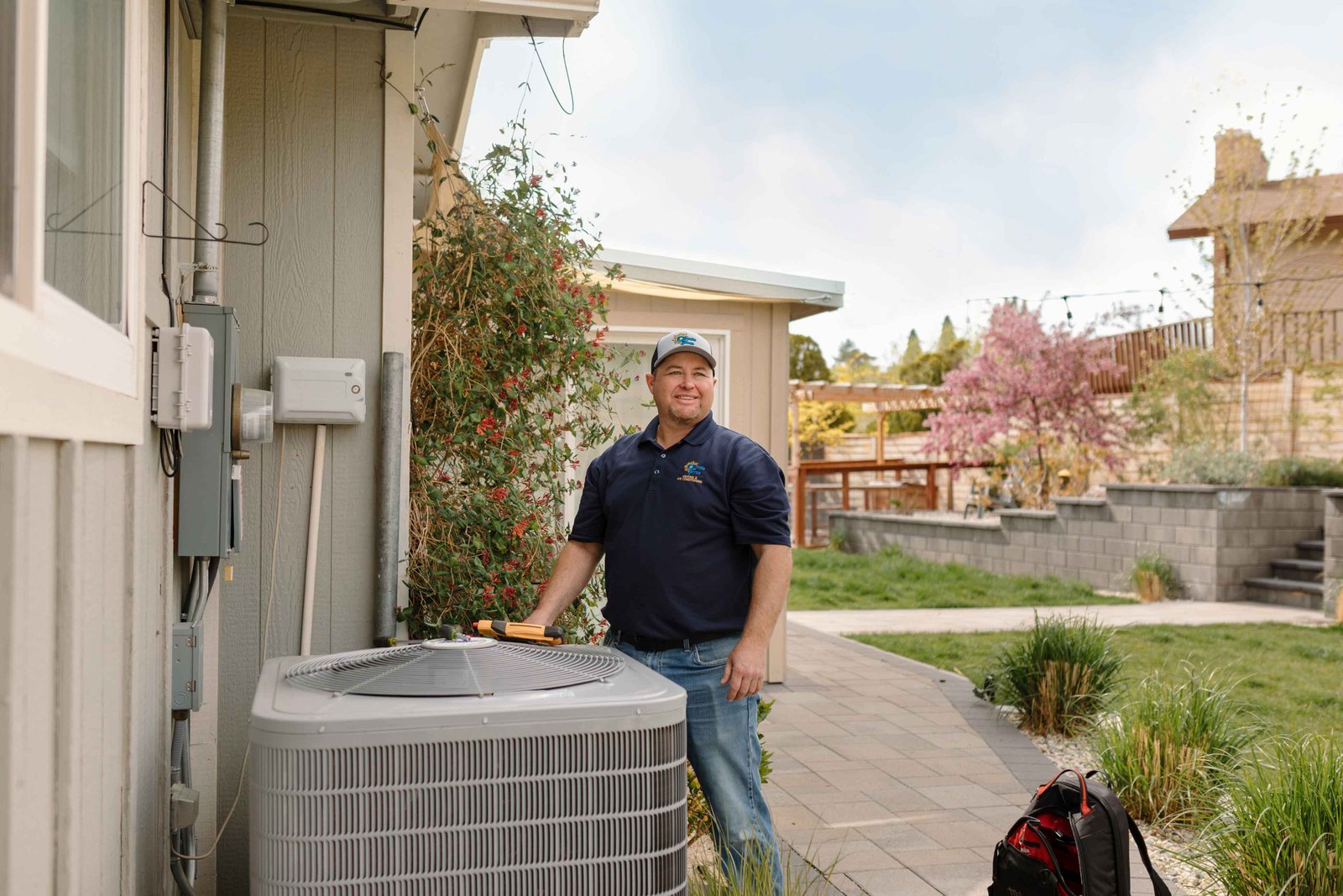 climate pros tech checking an old central ac system unit