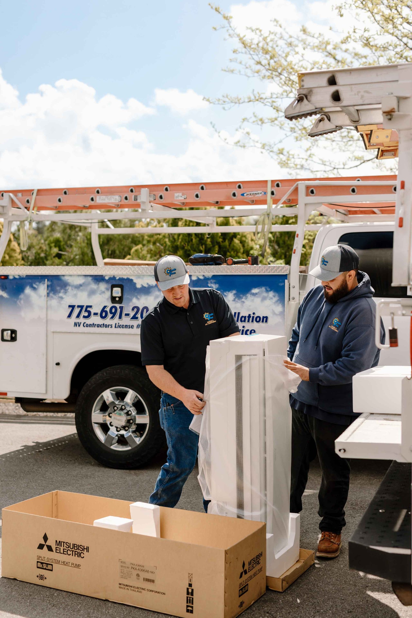 climate pros techs unloading a new ac unit ready for installation