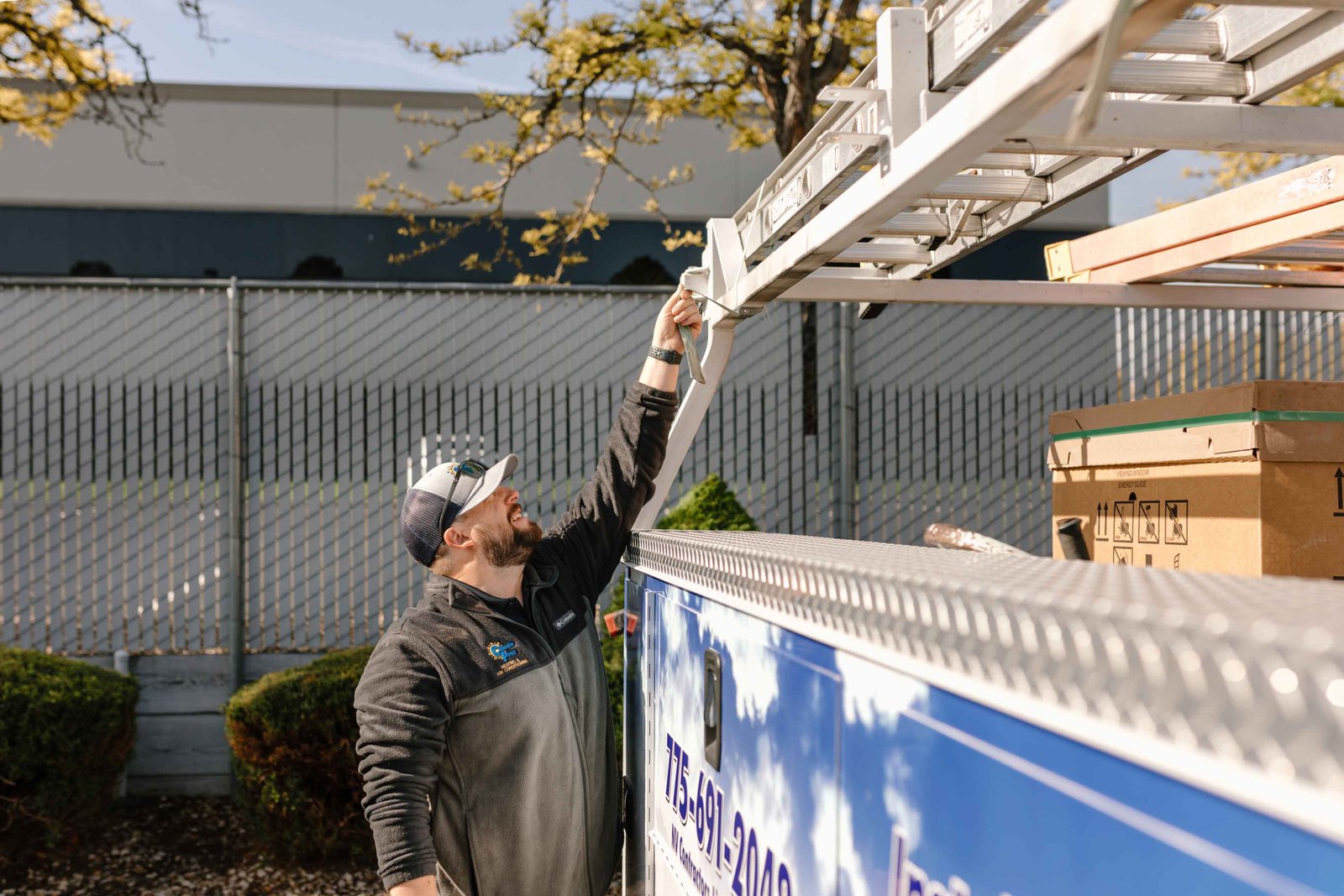 a climate pros tech checking his truck before going to do a heating system repair
