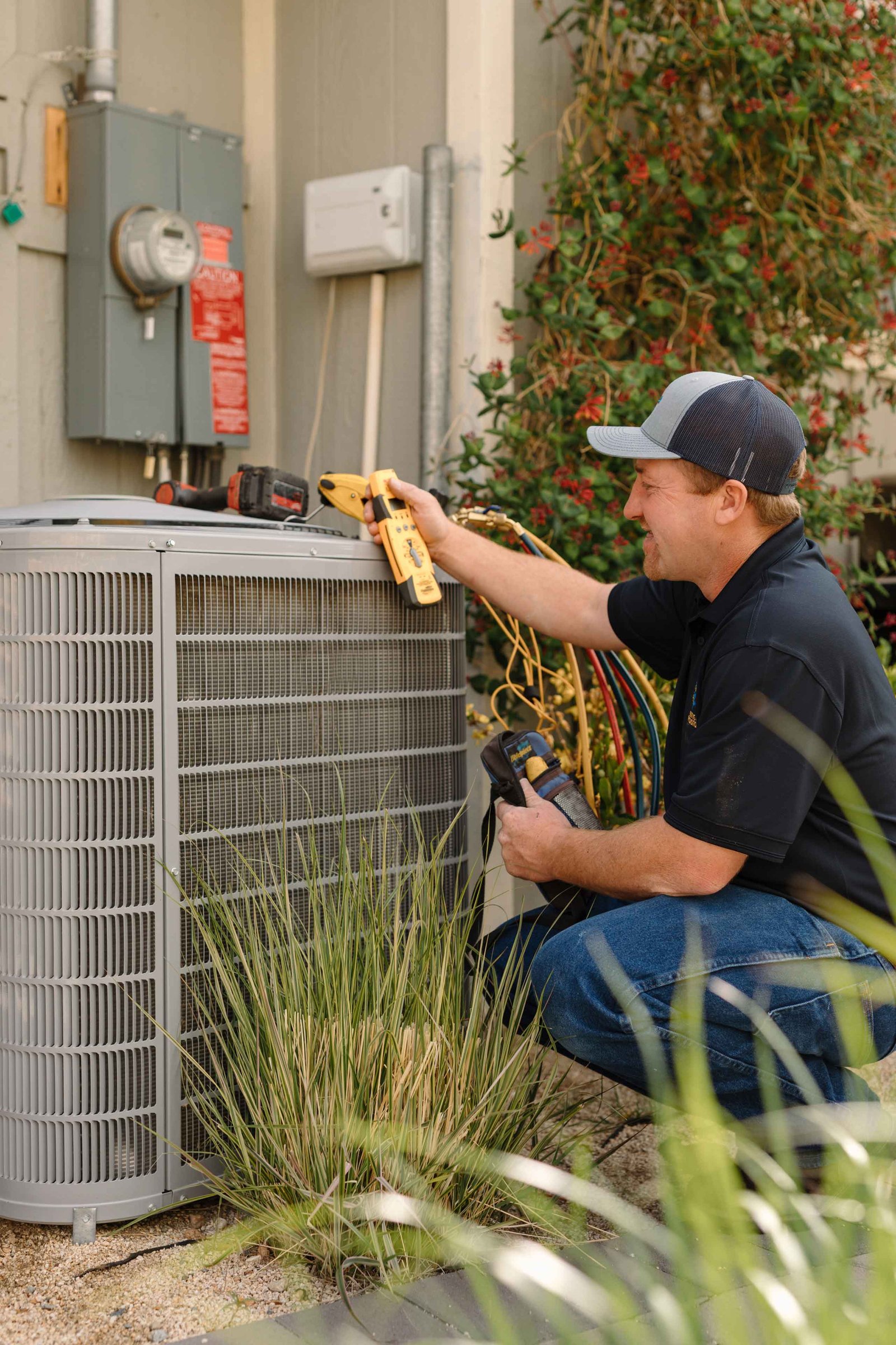 a climate pros tech inspecting a swamp cooler at a residential house