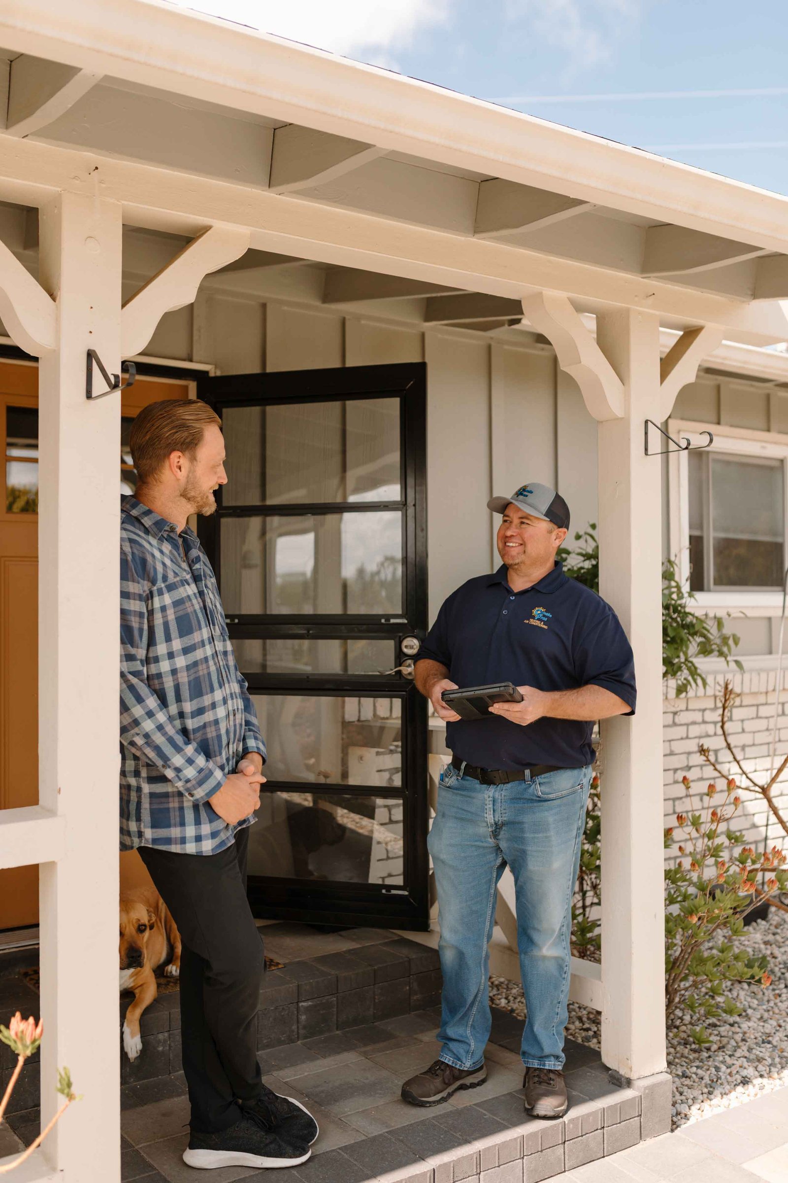 climate pros tech and client having a budget conversation for an ac repair