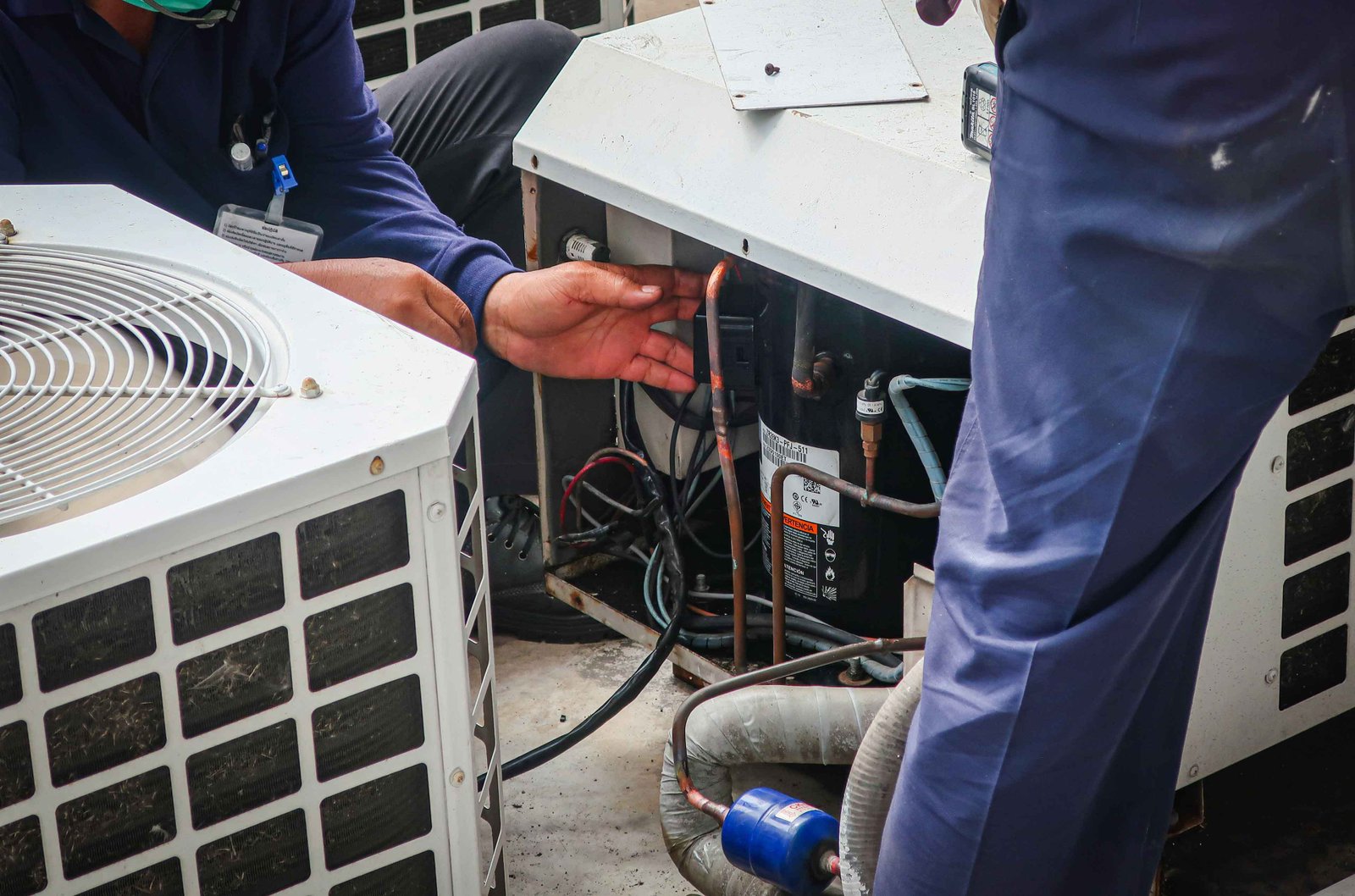 climate pros technicians doing a fix on a faulty swamp cooler unit