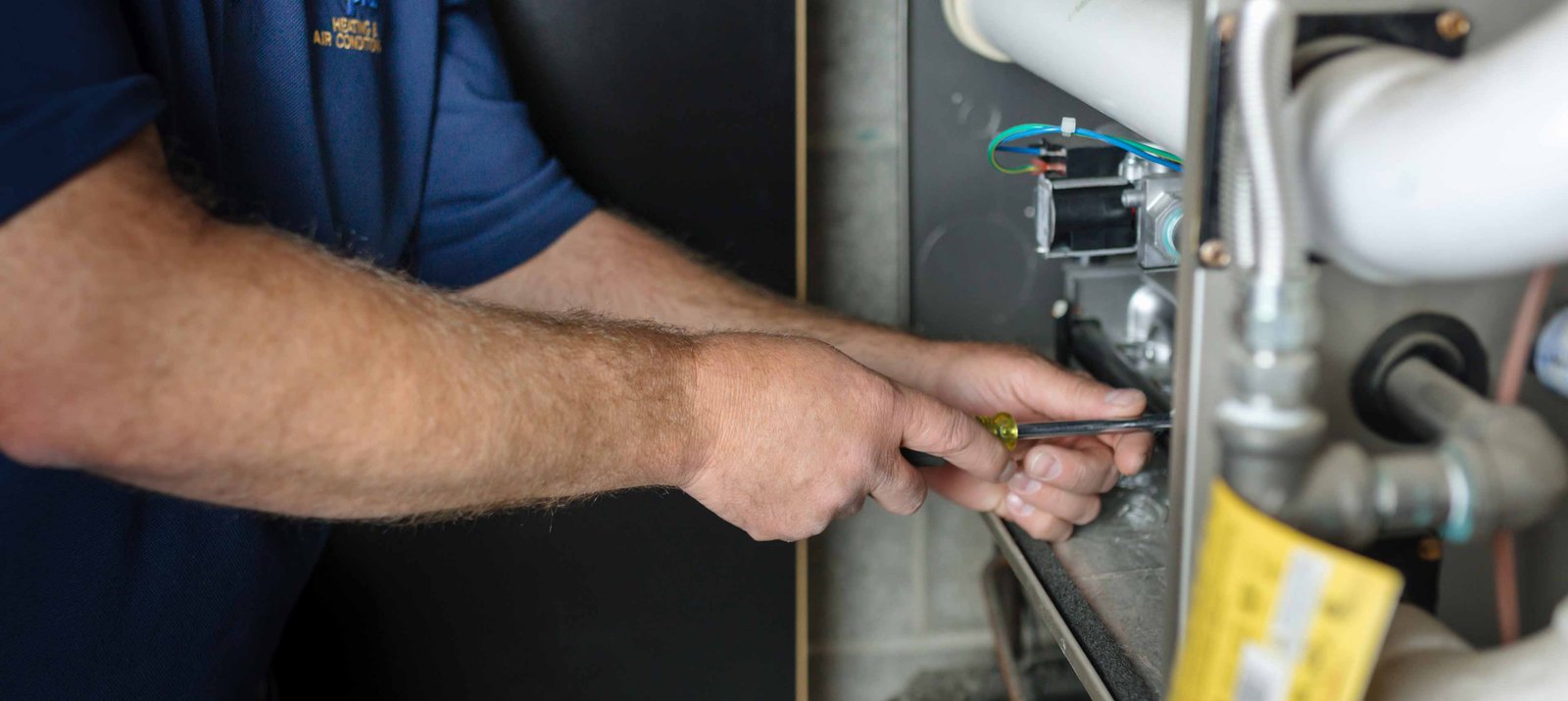 climate pros tech doing a round of maintenance on an ac unit