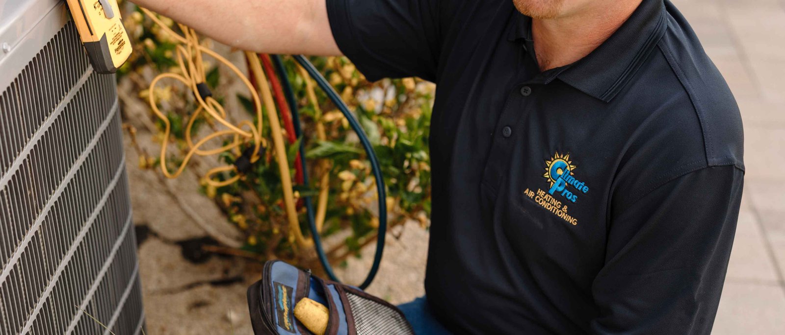 hvac pro doing a check on a swamp cooler unit