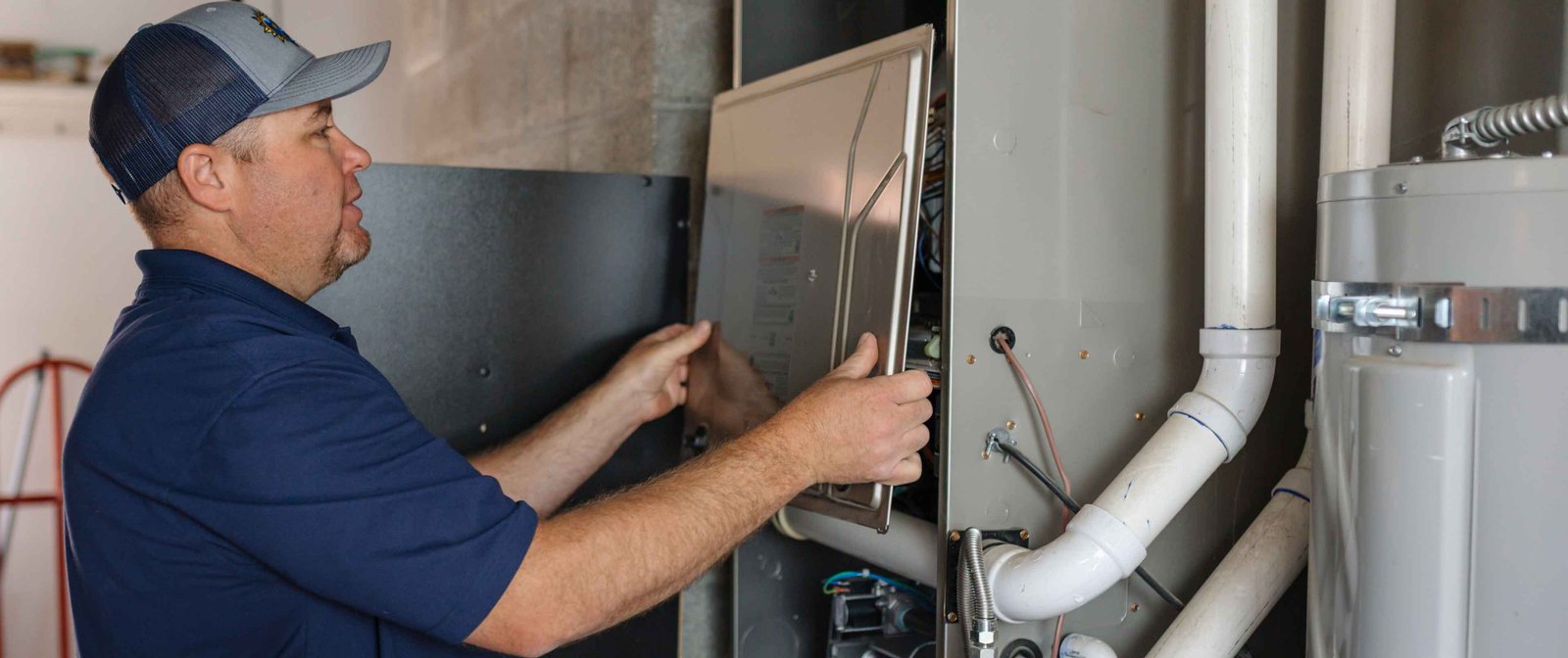 hvac tech checking a furnace system control panel